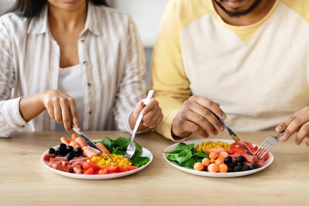 cropped couple sitting table eating breakfast 116547 94821