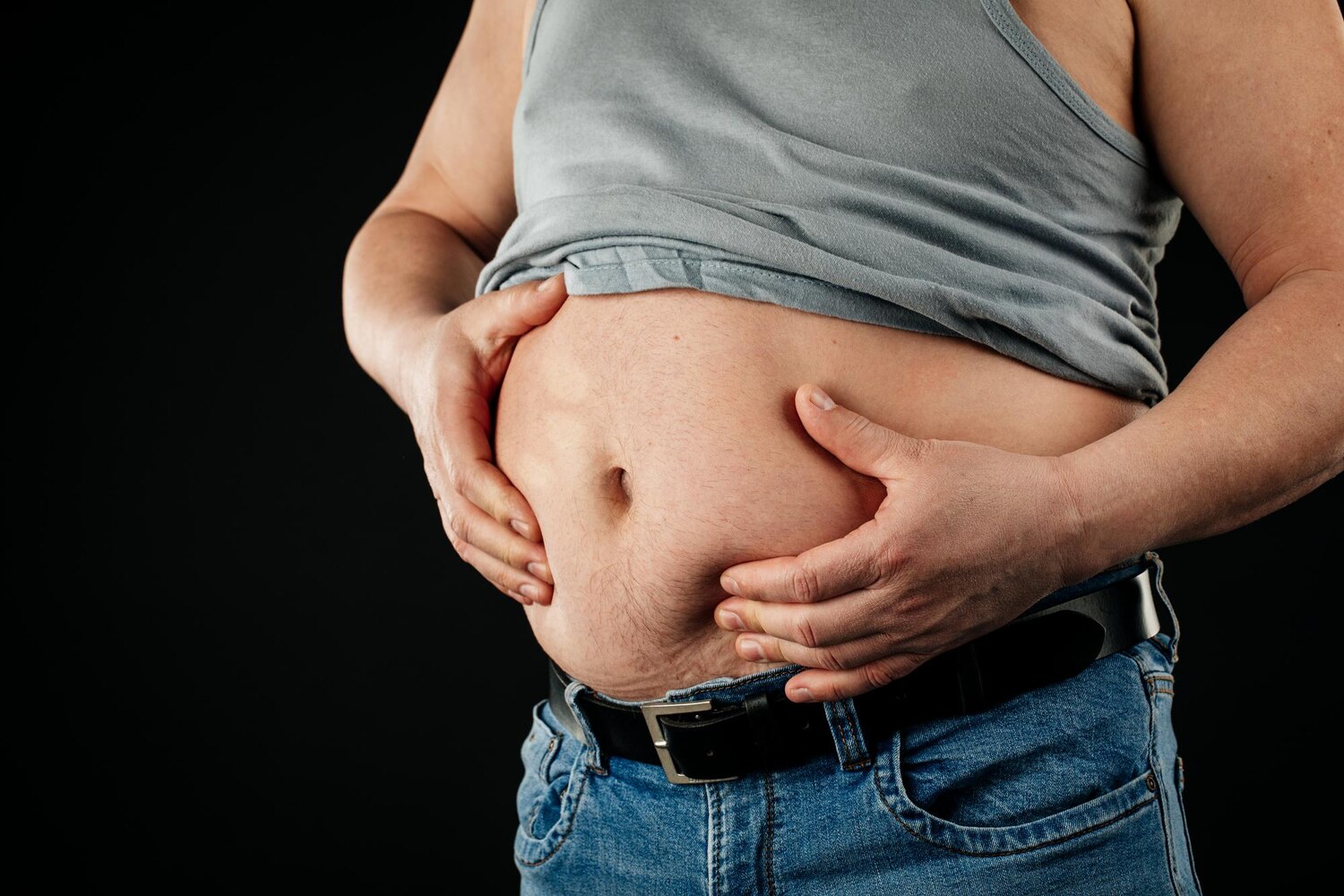 fat man checking his weight black background 544249 5777
